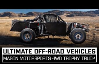 Off-road trophy truck in a desert landscape with mountains in the background, featuring large tires and a rugged frame, text at the bottom advertises ultimate off-road vehicles and Mason Motorsports 4WD trophy truck.