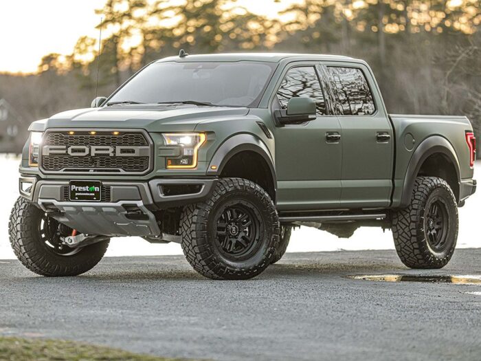 Ford Raptor front driver side view with 4" lift kit installed, army green color