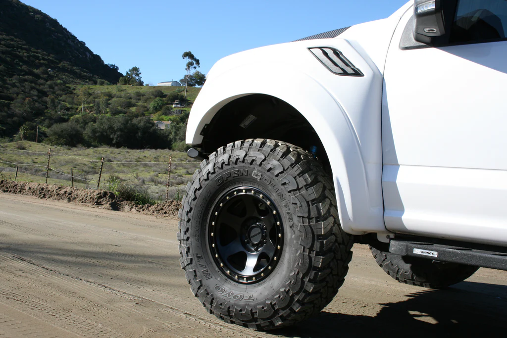 white ford raptor with FiberWorkx 2017-2020 Ford Raptor Fenders - 2.5" Bulge installed angle view of the front