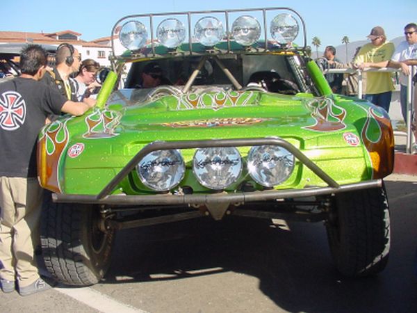 Jesse James Trophy Truck in Ensenada, MX at the beginning of the 2004 Baja 1000 Its a green trophy truck with huge lights on the bumper and roof
