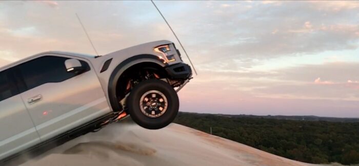 SwarfWorks - Ford Raptor Dune Flag Mount on white ford raptor jumping a sand dune