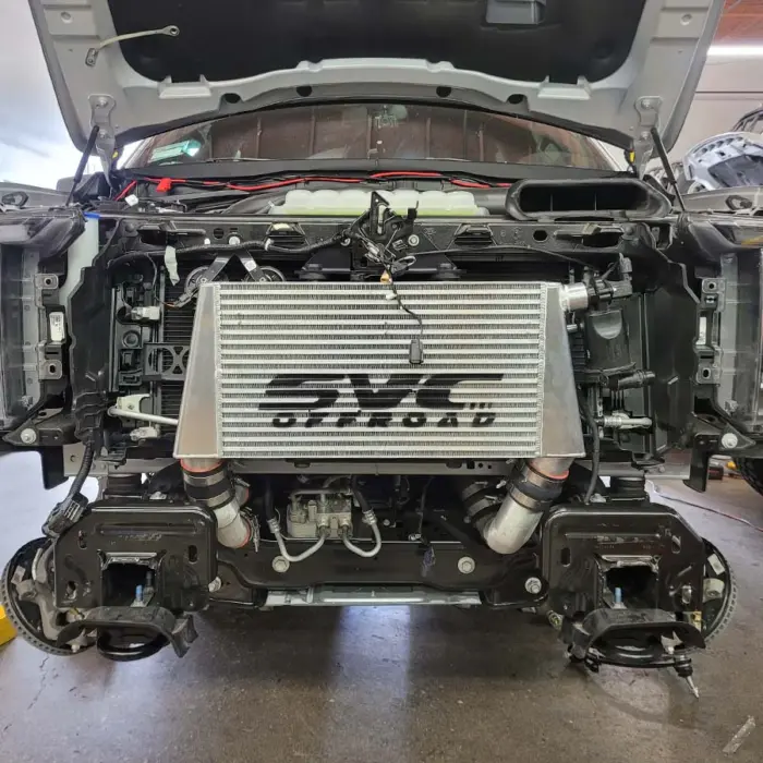 SVC Offroad intercooler installed on Ford Raptor pictured front view with front-end removed to show the intercooler